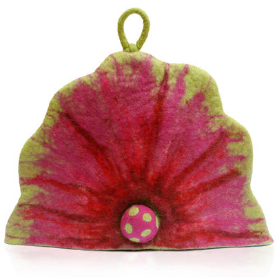A felt tea cosy with a green and pink spotted pattern and a red petal-like design at the base, with a felting needle included.